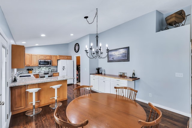 5885 Sandy Court Way, Nine Mile Falls, WA 99026 - dining space with vaulted ceiling, dark wood finished floors, a chandelier, and recessed lighting