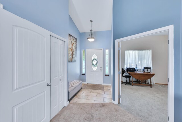 5885 Sandy Court Way, Nine Mile Falls, WA 99026 - entryway featuring light colored carpet, light tile patterned floors, and high vaulted ceiling
