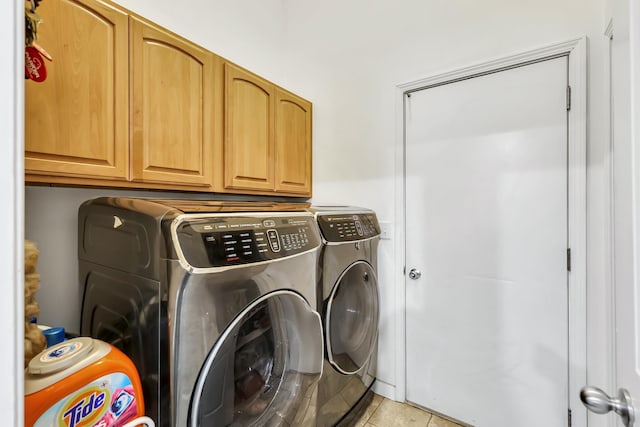 5885 Sandy Court Way, Nine Mile Falls, WA 99026 - laundry area with washer and clothes dryer, cabinet space, and light tile patterned floors