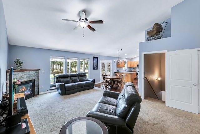 5885 Sandy Court Way, Nine Mile Falls, WA 99026 - living area with light colored carpet, a ceiling fan, a stone fireplace, and a chandelier