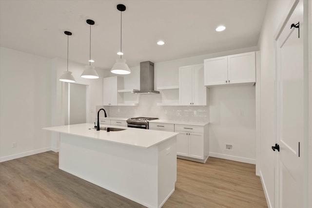 6203 E 13th Ln, Spokane Valley, WA 99212 - kitchen featuring wall chimney exhaust hood, stainless steel range with gas cooktop, open shelves, backsplash, and white cabinets