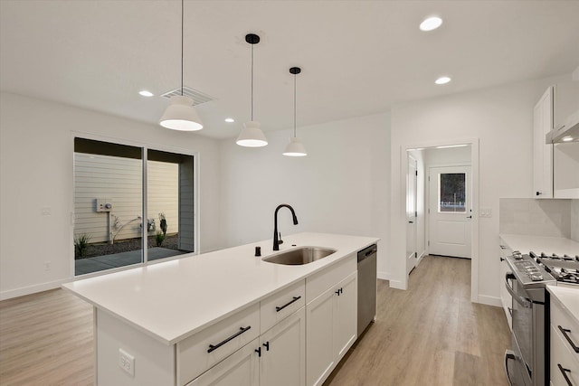 6203 E 13th Ln, Spokane Valley, WA 99212 - kitchen featuring stainless steel appliances, recessed lighting, light wood-style floors, white cabinets, and light countertops