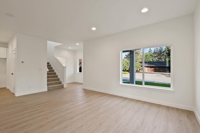 6203 E 13th Ln, Spokane Valley, WA 99212 - unfurnished living room featuring light wood-style flooring, stairway, and recessed lighting