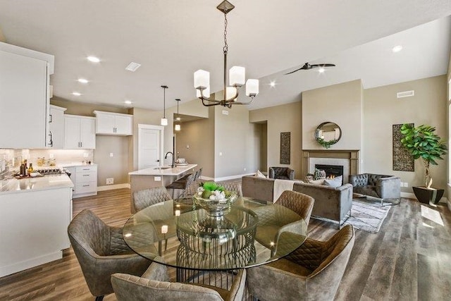 18096 N Morton Ct, Colbert, WA 99005 - dining space featuring a chandelier, dark wood finished floors, a tile fireplace, and recessed lighting