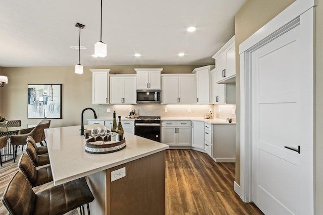 18096 N Morton Ct, Colbert, WA 99005 - kitchen with appliances with stainless steel finishes, decorative backsplash, dark wood-style floors, light countertops, and white cabinets