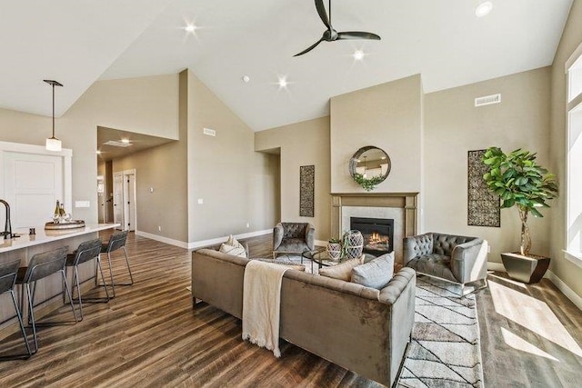 18096 N Morton Ct, Colbert, WA 99005 - living area featuring high vaulted ceiling, dark wood-type flooring, a ceiling fan, and a warm lit fireplace