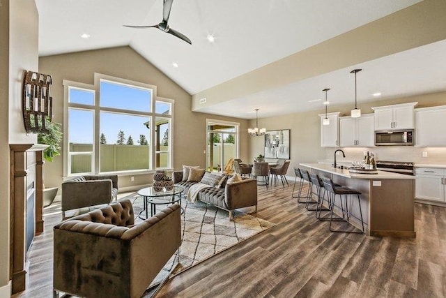 18096 N Morton Ct, Colbert, WA 99005 - living room featuring a ceiling fan, dark wood-type flooring, high vaulted ceiling, a chandelier, and recessed lighting