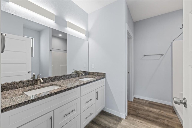 4919 E Grace Ave, Spokane, WA 99217 - bathroom with wood finished floors, double vanity, and a shower