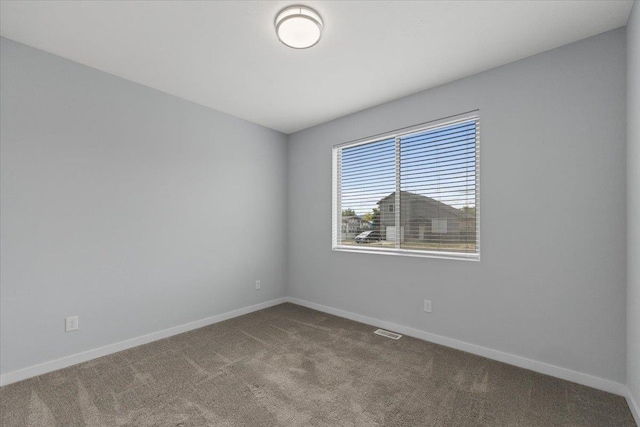 4919 E Grace Ave, Spokane, WA 99217 - empty room with carpet flooring and baseboards