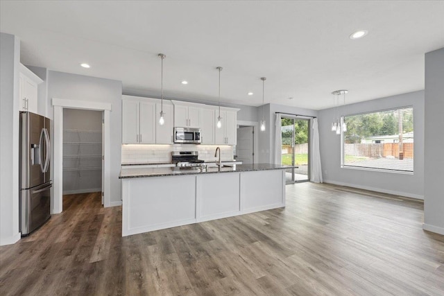4919 E Grace Ave, Spokane, WA 99217 - kitchen featuring stainless steel appliances, dark wood finished floors, white cabinets, backsplash, and recessed lighting