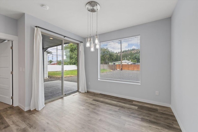 4919 E Grace Ave, Spokane, WA 99217 - unfurnished dining area featuring wood finished floors and baseboards
