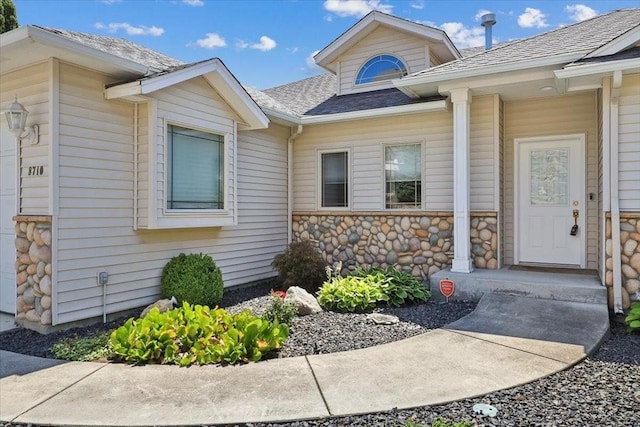 8710 E Sugar Pine Ln, Spokane, WA 99217 - doorway to property featuring a shingled roof and stone siding