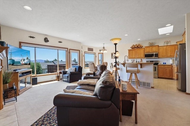 8710 E Sugar Pine Ln, Spokane, WA 99217 - living area with light carpet, recessed lighting, a skylight, and a textured ceiling