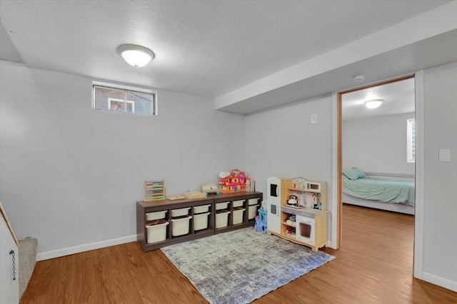 6914 N Jefferson St, Spokane, WA 99208 - rec room with wood finished floors, a textured ceiling, and healthy amount of natural light