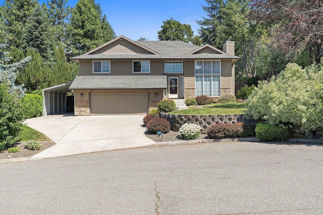 8603 E Columbia Park Dr, Spokane Valley, WA 99212 - view of front of home with driveway, stone siding, a chimney, a garage, and roof with shingles