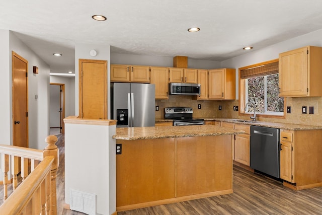 8603 E Columbia Park Dr, Spokane Valley, WA 99212 - kitchen featuring appliances with stainless steel finishes, dark wood-type flooring, decorative backsplash, light brown cabinetry, and recessed lighting