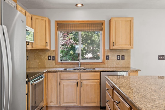 8603 E Columbia Park Dr, Spokane Valley, WA 99212 - kitchen featuring appliances with stainless steel finishes, light brown cabinets, tasteful backsplash, recessed lighting, and light stone countertops