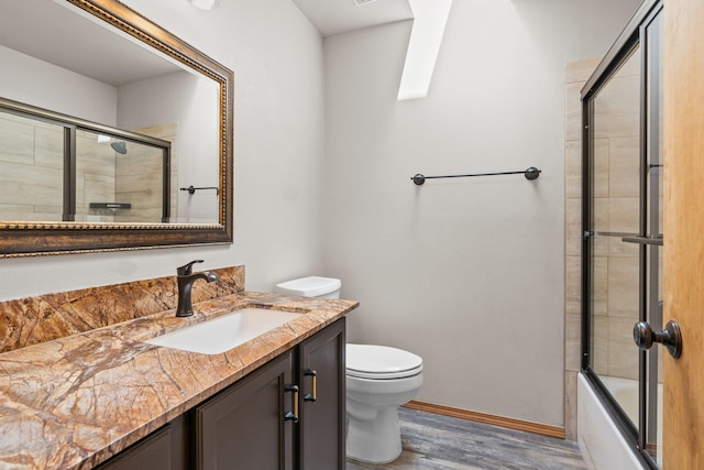 8603 E Columbia Park Dr, Spokane Valley, WA 99212 - full bathroom featuring vanity, wood finished floors, and combined bath / shower with glass door