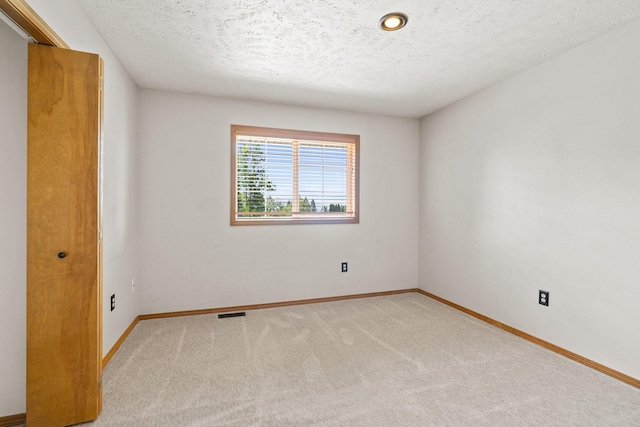 8603 E Columbia Park Dr, Spokane Valley, WA 99212 - unfurnished room with carpet flooring and a textured ceiling