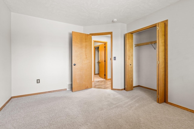 8603 E Columbia Park Dr, Spokane Valley, WA 99212 - unfurnished bedroom with light carpet, a closet, and a textured ceiling
