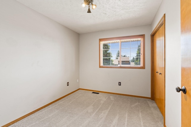 8603 E Columbia Park Dr, Spokane Valley, WA 99212 - unfurnished room with light colored carpet and a textured ceiling