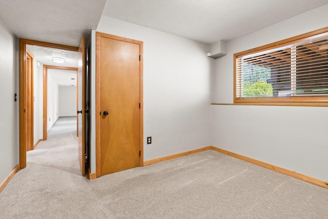 8603 E Columbia Park Dr, Spokane Valley, WA 99212 - unfurnished bedroom featuring light colored carpet and a textured ceiling