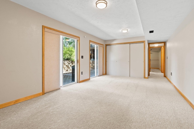 8603 E Columbia Park Dr, Spokane Valley, WA 99212 - unfurnished bedroom featuring access to outside, carpet, a textured ceiling, and a closet