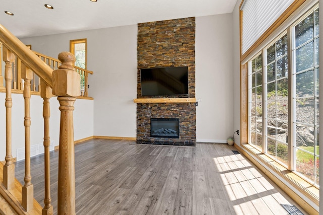 8603 E Columbia Park Dr, Spokane Valley, WA 99212 - unfurnished living room featuring a fireplace, wood finished floors, recessed lighting, and stairway