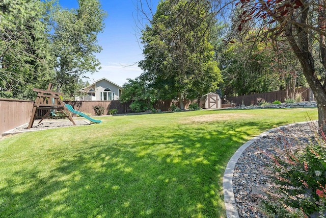 8603 E Columbia Park Dr, Spokane Valley, WA 99212 - fenced backyard featuring a storage unit and a playground