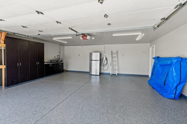 8603 E Columbia Park Dr, Spokane Valley, WA 99212 - garage featuring freestanding refrigerator and a garage door opener