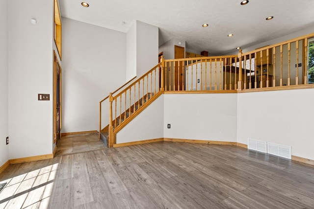 8603 E Columbia Park Dr, Spokane Valley, WA 99212 - unfurnished living room featuring recessed lighting, wood finished floors, and stairway