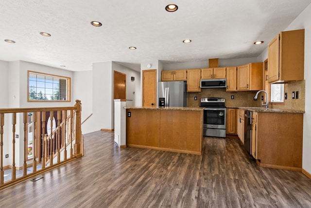 8603 E Columbia Park Dr, Spokane Valley, WA 99212 - kitchen with appliances with stainless steel finishes, dark wood-style flooring, stone countertops, decorative backsplash, and recessed lighting