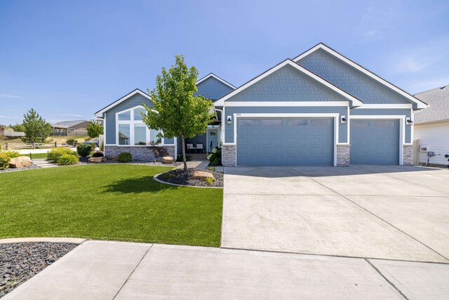 705 W Basalt Ridge Dr, Spokane, WA 99224 - craftsman inspired home with an attached garage, a front yard, stone siding, and concrete driveway