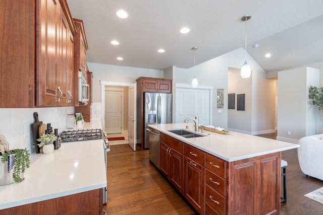 705 W Basalt Ridge Dr, Spokane, WA 99224 - kitchen featuring appliances with stainless steel finishes, a kitchen island with sink, dark wood-style floors, a breakfast bar area, and recessed lighting