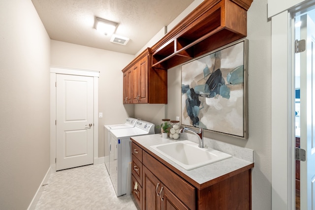 705 W Basalt Ridge Dr, Spokane, WA 99224 - washroom with washing machine and clothes dryer, cabinet space, and a textured ceiling
