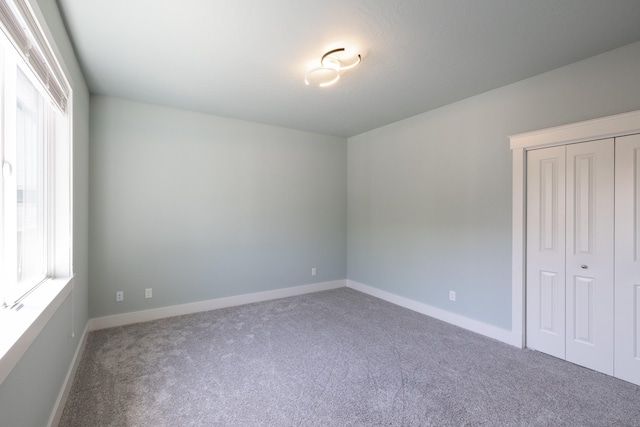 705 W Basalt Ridge Dr, Spokane, WA 99224 - unfurnished bedroom featuring carpet flooring, multiple windows, and a closet