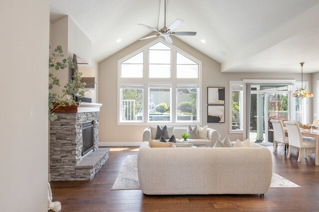 705 W Basalt Ridge Dr, Spokane, WA 99224 - living room with a ceiling fan, a stone fireplace, dark wood-style flooring, and lofted ceiling