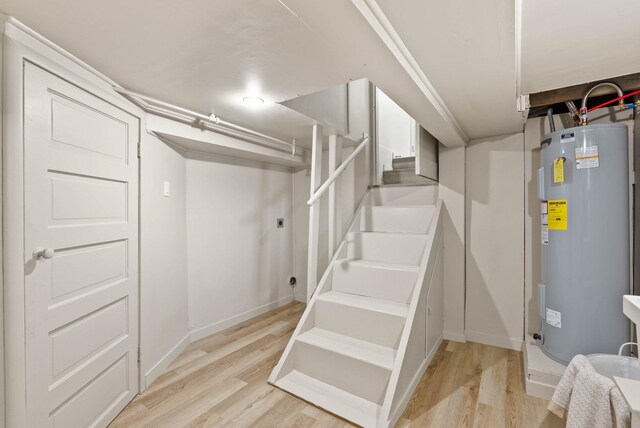 1115 E Everett Ave, Spokane, WA 99207 - finished basement with electric water heater, light wood-type flooring, and stairway