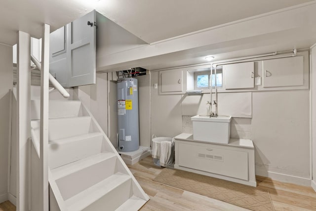 1115 E Everett Ave, Spokane, WA 99207 - below grade area with water heater, light wood finished floors, and stairs