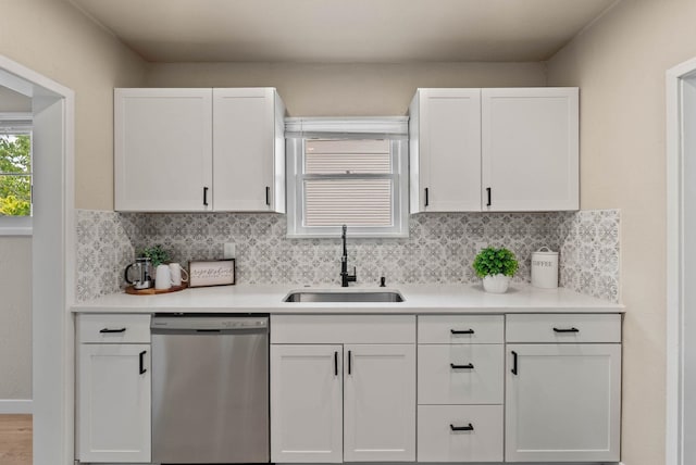 1115 E Everett Ave, Spokane, WA 99207 - kitchen with stainless steel dishwasher, white cabinetry, light countertops, and tasteful backsplash