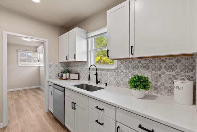 1115 E Everett Ave, Spokane, WA 99207 - kitchen with dishwasher, light wood-style floors, tasteful backsplash, and white cabinets