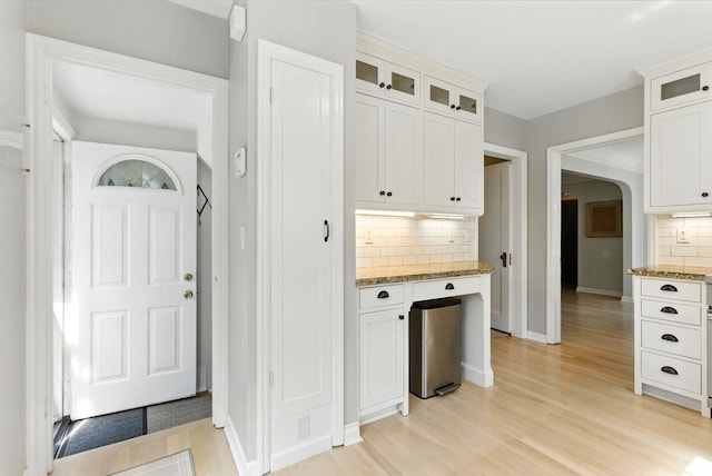 914 E 17th Ave, Spokane, WA 99203 - kitchen with decorative backsplash, light wood finished floors, light stone counters, and white cabinets