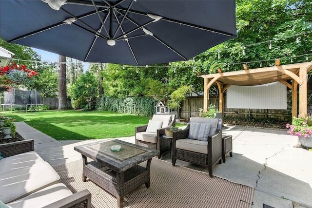 914 E 17th Ave, Spokane, WA 99203 - fenced backyard with a trampoline, an outdoor living space, a patio, and a pergola
