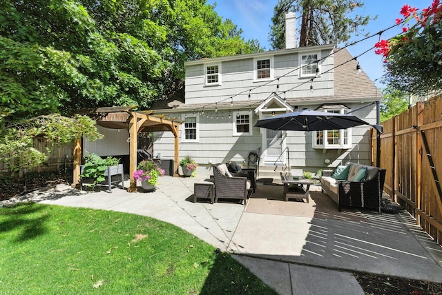 914 E 17th Ave, Spokane, WA 99203 - back of property featuring an outdoor living space, a pergola, a fenced backyard, a patio, and a chimney