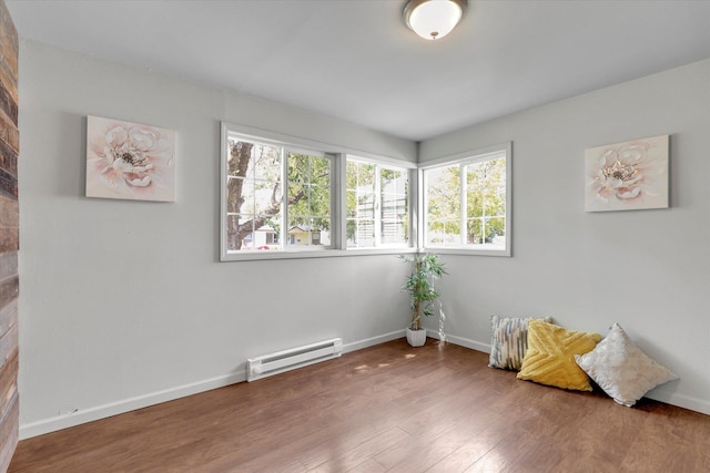 5704 N Milton St, Spokane, WA 99205 - spare room featuring a baseboard heating unit and wood finished floors