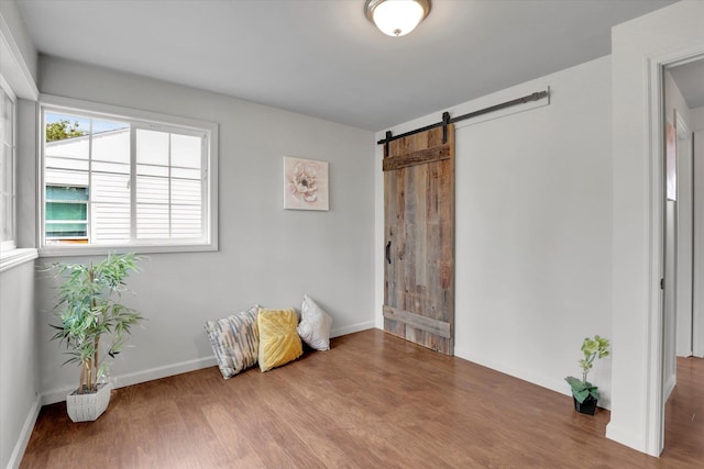 5704 N Milton St, Spokane, WA 99205 - bedroom featuring a barn door and wood finished floors