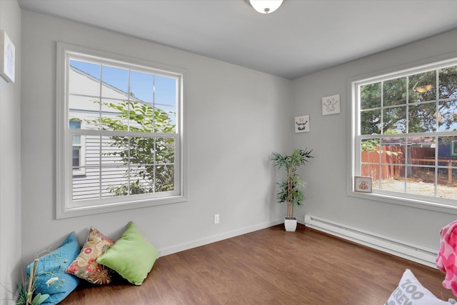 5704 N Milton St, Spokane, WA 99205 - unfurnished room featuring a baseboard radiator, plenty of natural light, and dark wood-type flooring