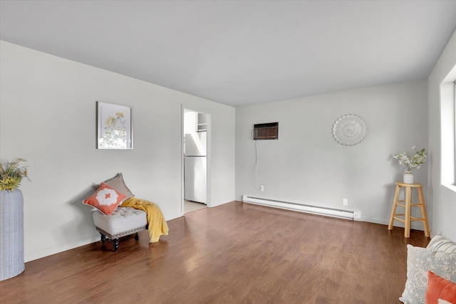 5704 N Milton St, Spokane, WA 99205 - living area featuring a baseboard heating unit, wood finished floors, and a wall mounted AC