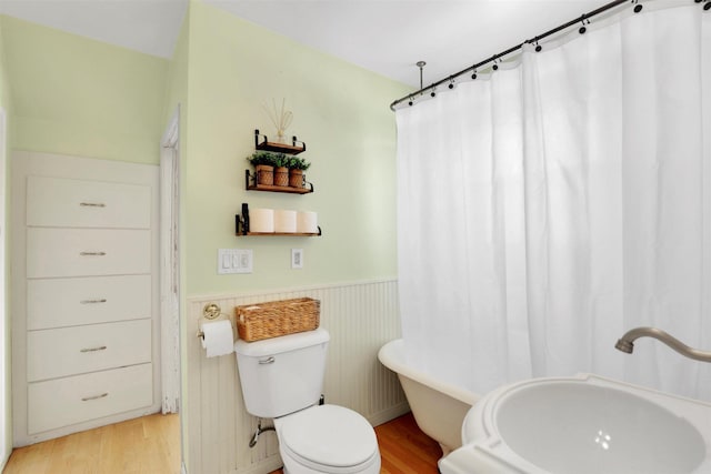 3504 W 2nd Ave, Spokane, WA 99224 - full bathroom with wainscoting, wood finished floors, a freestanding tub, and curtained shower