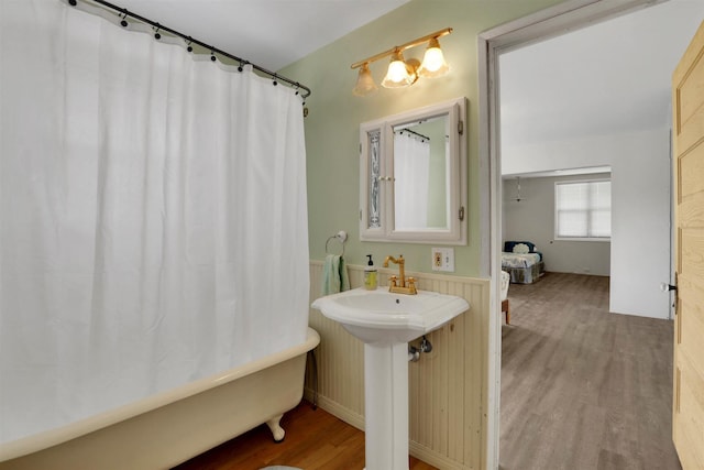 3504 W 2nd Ave, Spokane, WA 99224 - bathroom with wood finished floors, a tub to relax in, and a shower with curtain